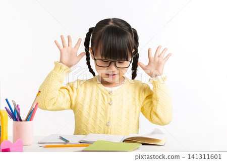 Asian schoolgirl showing various emotions while doing homework, feeling confused, inspired, and excited. Asian schoolgirl showing various emotions while doing homework, feeling confused, inspired, and excited. 141311601