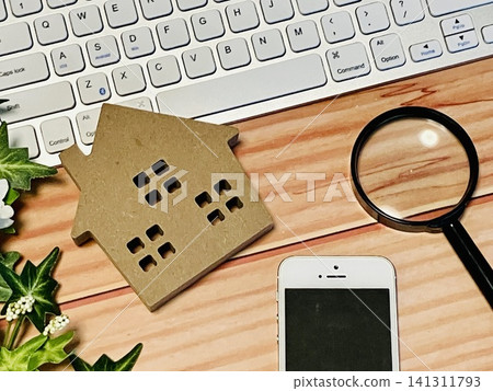 House ornaments, a magnifying glass, a smartphone, a calculator, and a PC House ornaments, a magnifying glass, a smartphone, a calculator, and a PC 141311793