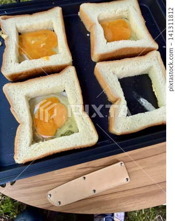 Fried eggs cooked on a griddle Fried eggs cooked on a griddle 141311812