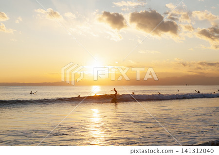 Surfing in the evening at Kugenuma Beach, Shonan. Surfing in the evening at Kugenuma Beach, Shonan. 141312040