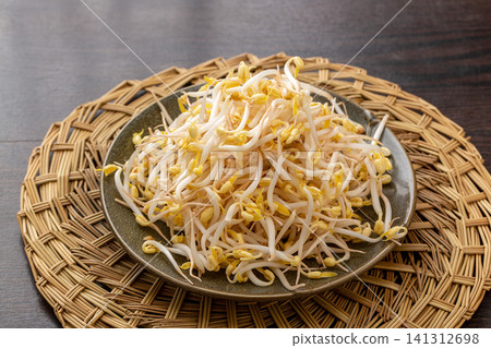fresh crunchy bean sprouts on a ceramic plate, a classic topping ingredient for Chinese noodles. fresh crunchy bean sprouts on a ceramic plate, a classic topping ingredient for Chinese noodles. 141312698