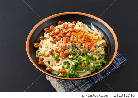 handmade flat wheat noodles with sesame paste and peanut toppings, authentic Chinese regional dish. handmade flat wheat noodles with sesame paste and peanut toppings, authentic Chinese regional dish. 141312716