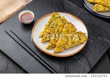 crispy golden egg pancake with edible acacia flowers crispy golden egg pancake with edible acacia flowers 141312731
