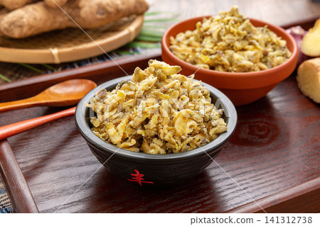 traditional Chinese steamed acacia flowers mixed with flour, served on a vintage wooden tray with dipping sauce. traditional Chinese steamed acacia flowers mixed with flour, served on a vintage wooden tray with dipping sauce. 141312738