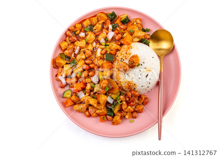 spicy Chinese Kung Pao chicken with peanuts and vegetables served over white rice on a pink plate. spicy Chinese Kung Pao chicken with peanuts and vegetables served over white rice on a pink plate. 141312767