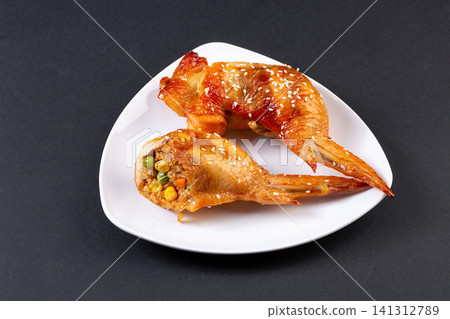 delicious grilled whole chicken wings stuffed with seasoned glutinous rice and vegetables delicious grilled whole chicken wings stuffed with seasoned glutinous rice and vegetables 141312789