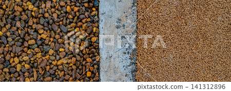 Small brown gravel pebbles next to gray concrete surface showing texture contrast, landscaping and construction material concept Small brown gravel pebbles next to gray concrete surface showing texture contrast, landscaping and construction material concept 141312896