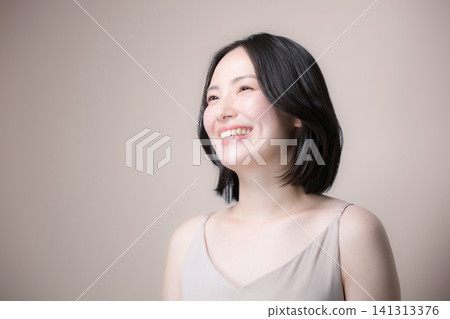 A beautiful Japanese woman with a pinkish-beige background and a lovely smile, showcasing her beautiful bare skin and natural makeup. A beautiful Japanese woman with a pinkish-beige background and a lovely smile, showcasing her beautiful bare skin and natural makeup. 141313376