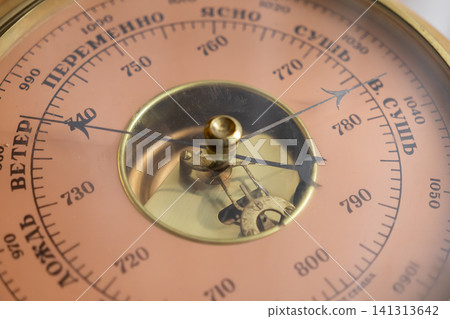 A vintage brass barometer displays atmospheric pressure levels on a metallic dial face, highlighting precise mechanical engineering and traditional meteorological measurement tools now A vintage brass barometer displays atmospheric pressure levels on a metallic dial face, highlighting precise mechanical engineering and traditional meteorological measurement tools now 141313642