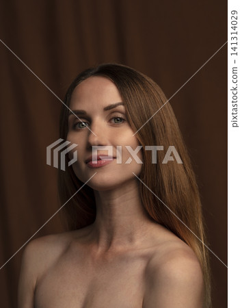 portrait of a young beautiful woman on a dark background portrait of a young beautiful woman on a dark background 141314029