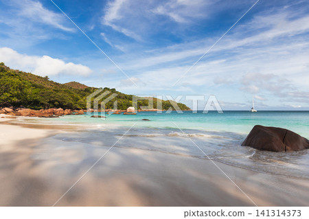Anse Lazio beach, wide white sandy shore is under blue sky Anse Lazio beach, wide white sandy shore is under blue sky 141314373