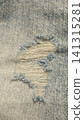 Close-up of a torn hole in jeans fabric 141315281