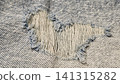 Close-up of a torn hole in jeans fabric 141315282