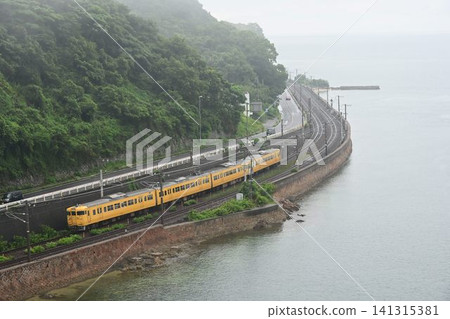 A 115 series train passing along the Sanyo Main Line, the Setouchi Coast Line, viewed from an aerial perspective from Ohata Bridge. 141315381