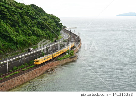 A 115 series train passing along the Sanyo Main Line, the Setouchi Coast Line, viewed from an aerial perspective from Ohata Bridge. 141315388
