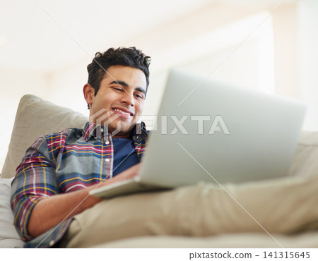 Man, laptop and sofa for relax connection with streaming service for free time, stress relief or resting. Male person, smile and couch with technology for online subscription, watching or internet Man, laptop and sofa for relax connection with streaming service for free time, stress relief or resting. Male person, smile and couch with technology for online subscription, watching or internet 141315645