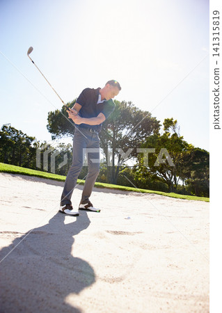 Man, golfer and swing with club in sand pit by grass field for point, score or par in outdoor nature. Male person or sports player hitting ball out of dirt on green lawn or golf course with blue sky 141315819