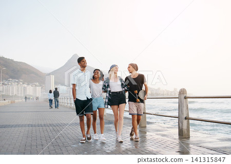 Group, friends and walk on promenade by ocean with smile for diversity, bonding and space for mockup. Men, women or gen z people with conversation, happy and outdoor on boardwalk by sea for vacation Group, friends and walk on promenade by ocean with smile for diversity, bonding and space for mockup. Men, women or gen z people with conversation, happy and outdoor on boardwalk by sea for vacation 141315847