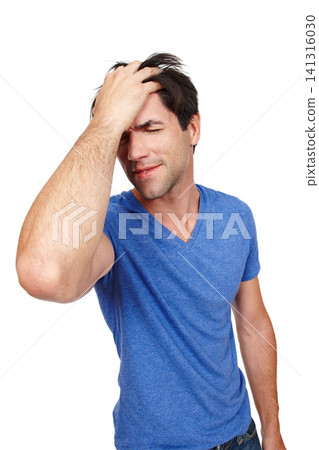 Frustrated, man and pain from headache in studio for anxiety, depression, burnout and mental health issues. Stressed, person and standing with extreme migraine problems in isolated white background 141316030