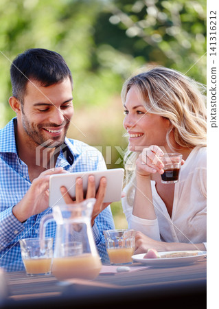 Happy couple, smiling and tablet in garden for breakfast, internet and scrolling on social media. Male person, woman and outdoors at home for mobile games, meme and communication in the morning Happy couple, smiling and tablet in garden for breakfast, internet and scrolling on social media. Male person, woman and outdoors at home for mobile games, meme and communication in the morning 141316212
