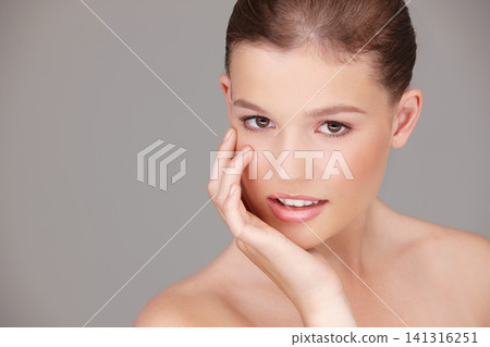 Beauty, cosmetics and portrait of woman in studio for dermatology, wellness or facial treatment with gray background. Skincare, smile and female model for healthy skin, cosmetics or natural glow Beauty, cosmetics and portrait of woman in studio for dermatology, wellness or facial treatment with gray background. Skincare, smile and female model for healthy skin, cosmetics or natural glow 141316251