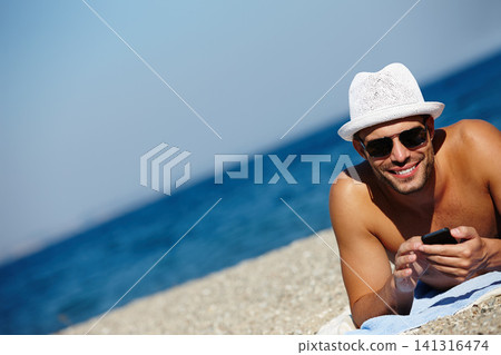 Man, beach and smartphone in portrait on holiday with ocean on seashore with blue sky in summer for peace. Male person, vacation and relax with phone for memories in cancun with wellness on trip 141316474