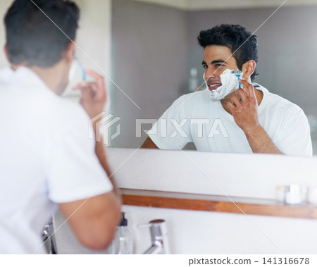 Foam, mirror and man with razor in bathroom for hygiene, grooming and washing face at home, house and apartment. Male person, gen z guy and reflection of student with shaving cream, face or skin care Foam, mirror and man with razor in bathroom for hygiene, grooming and washing face at home, house and apartment. Male person, gen z guy and reflection of student with shaving cream, face or skin care 141316678
