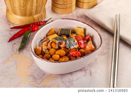 Bowl of mixed savory snack with nori, peanuts, and chili peppers Bowl of mixed savory snack with nori, peanuts, and chili peppers 141316985