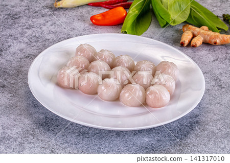 Steamed dumplings on white plate with fresh ingredients background Steamed dumplings on white plate with fresh ingredients background 141317010