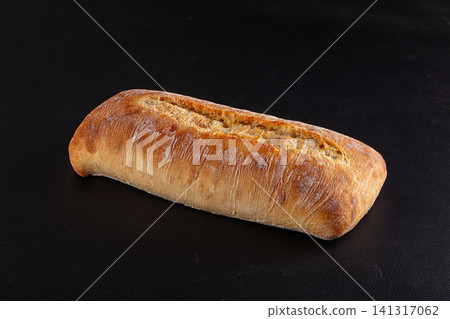 Freshly baked artisan bread loaf on black background Freshly baked artisan bread loaf on black background 141317062