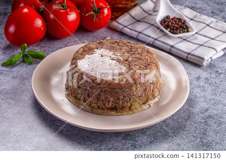 Meat terrine on plate with fresh tomatoes and basil 141317150