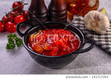 Tomato sauce in black bowl with fresh ingredients 141317263