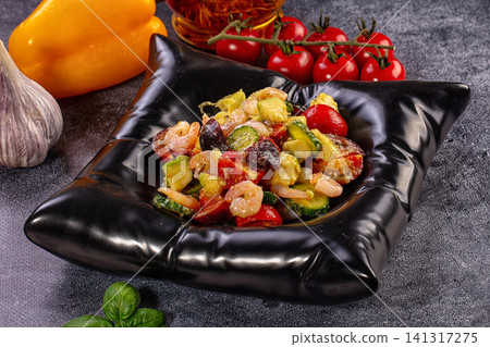 Shrimp and vegetable salad in black bowl with fresh ingredients 141317275