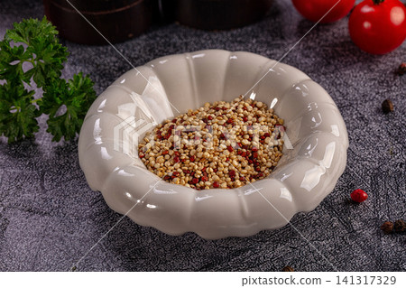 Quinoa in ceramic bowl with parsley and tomatoes on textured surface Quinoa in ceramic bowl with parsley and tomatoes on textured surface 141317329