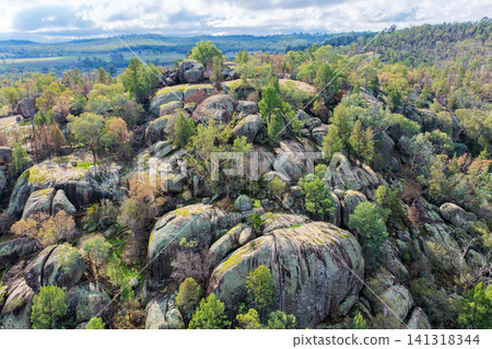 Aerial view of the dramatic granite rock formations and natural landscape at Cranky Rock Nature Reserve near Warialda, NSW. Surrounded by native bushland Aerial view of the dramatic granite rock formations and natural landscape at Cranky Rock Nature Reserve near Warialda, NSW. Surrounded by native bushland 141318344