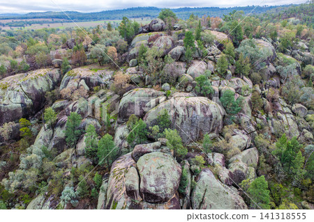 Aerial view of the dramatic granite rock formations and natural landscape at Cranky Rock Nature Reserve near Warialda, NSW. Surrounded by native bushland Aerial view of the dramatic granite rock formations and natural landscape at Cranky Rock Nature Reserve near Warialda, NSW. Surrounded by native bushland 141318555
