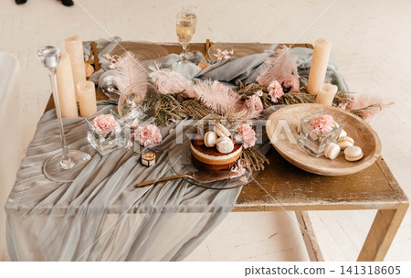 Wedding cake with flowers and macaroons. Beautiful table design with flowers and candles for serving a wedding cake. Wedding cake with flowers and macaroons. Beautiful table design with flowers and candles for serving a wedding cake. 141318605
