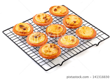 baked Portuguese egg tarts flaky pastry shells with strawberry custard filling baked Portuguese egg tarts flaky pastry shells with strawberry custard filling 141318830