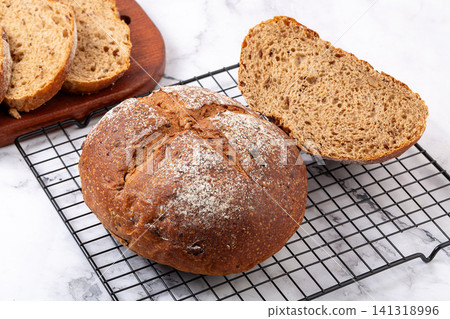whole rye malt multigrain bread loaves with cereal seeds dusting 141318996