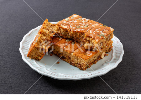 sliced jujube brown sugar cake topped with mixed nuts and seeds 141319115