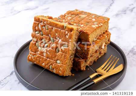 sliced jujube brown sugar cake topped with mixed nuts and seeds sliced jujube brown sugar cake topped with mixed nuts and seeds 141319119