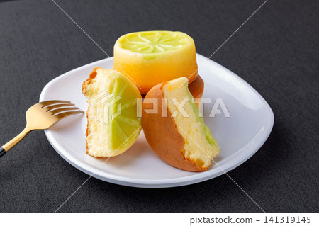 mini lime sponge cake with vibrant green citrus topping 141319145