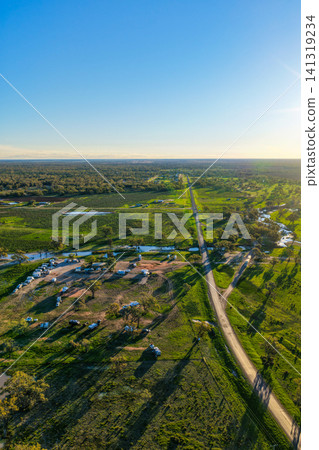Aerial vertical scene showcasing the Pilliga Artesian Bore Baths and adjacent campground, surrounded by lush green bushland and peaceful rural scenery near Pilliga, NSW, Australia. Aerial vertical scene showcasing the Pilliga Artesian Bore Baths and adjacent campground, surrounded by lush green bushland and peaceful rural scenery near Pilliga, NSW, Australia. 141319234
