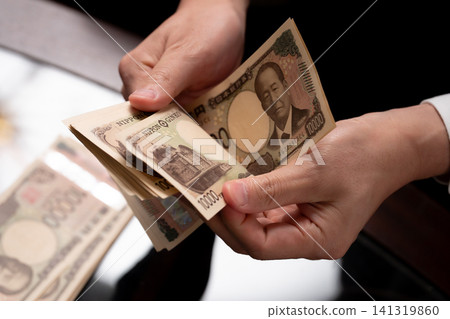 A man counting money A man counting money 141319860