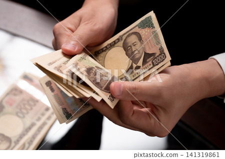A man counting money A man counting money 141319861