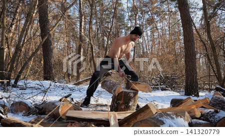 Shirtless strong man chopping firewood in a sunny winter forest. Muscular guy working with axe in snowy woodland. Concept of strength, masculine, energy and harmony with nature during cold season Shirtless strong man chopping firewood in a sunny winter forest. Muscular guy working with axe in snowy woodland. Concept of strength, masculine, energy and harmony with nature during cold season 141320779