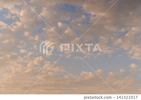 View of warm sunset clouds in the evening sky. View of warm sunset clouds in the evening sky. 141321017
