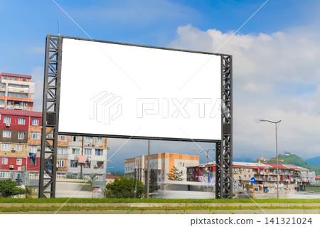 Mock up: white billboard or large display against moving car traffic Mock up: white billboard or large display against moving car traffic 141321024