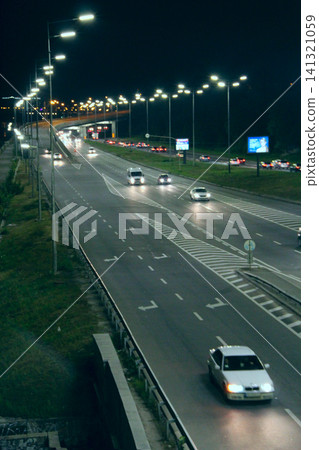 Multiband city highway with driving cars and bright street lights at night Multiband city highway with driving cars and bright street lights at night 141321059