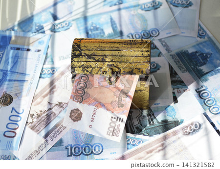An antique wooden chest filled with Russian rubles An antique wooden chest filled with Russian rubles 141321582
